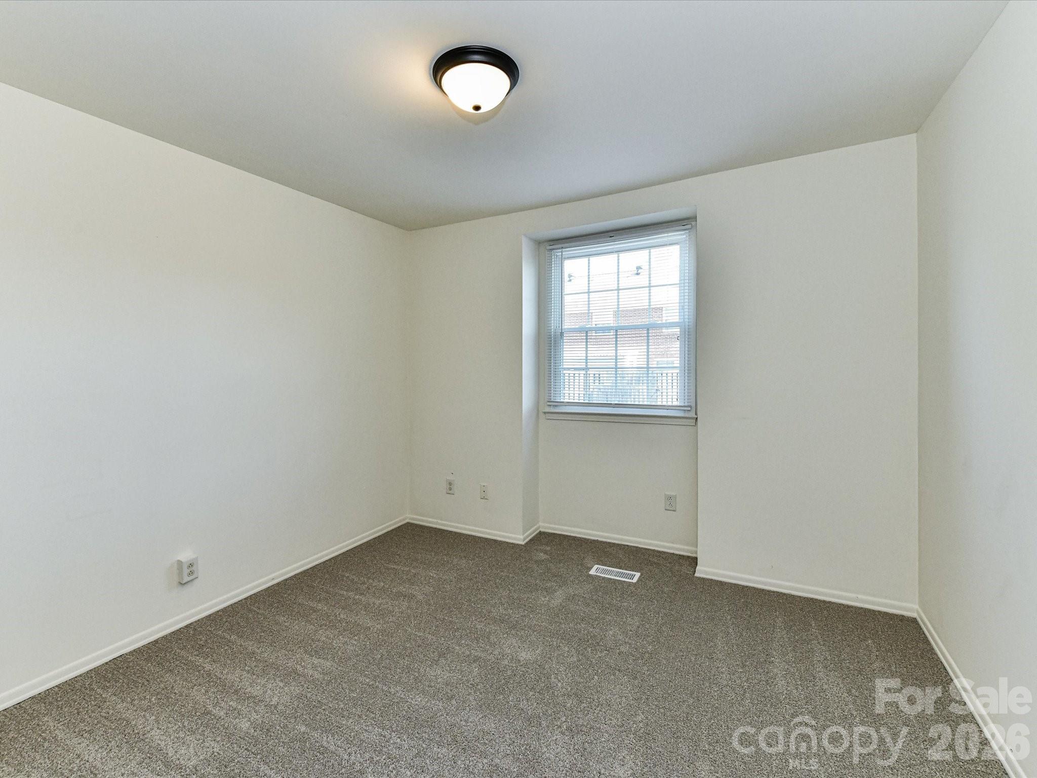 8322 Knights Bridge Road Charlotte, NC 28210 - Photo 32 of 37 an empty room with windows