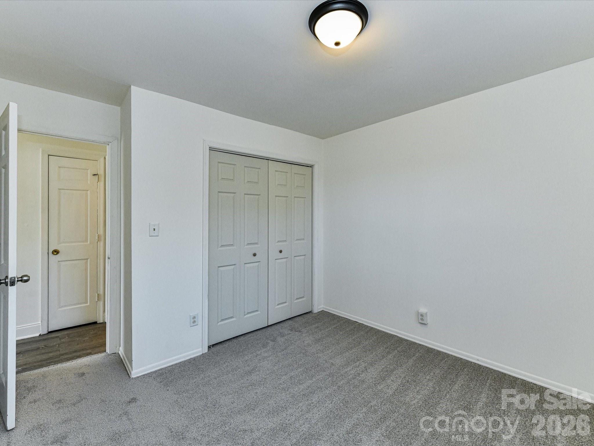 8322 Knights Bridge Road Charlotte, NC 28210 - Photo 33 of 37 an empty room with windows