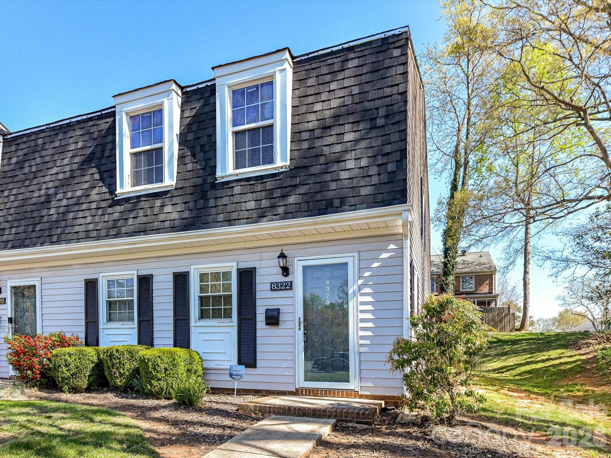 8322 Knights Bridge Road Charlotte, NC 28210 - Photo 6 of 37 a view of a brick building next to a yard