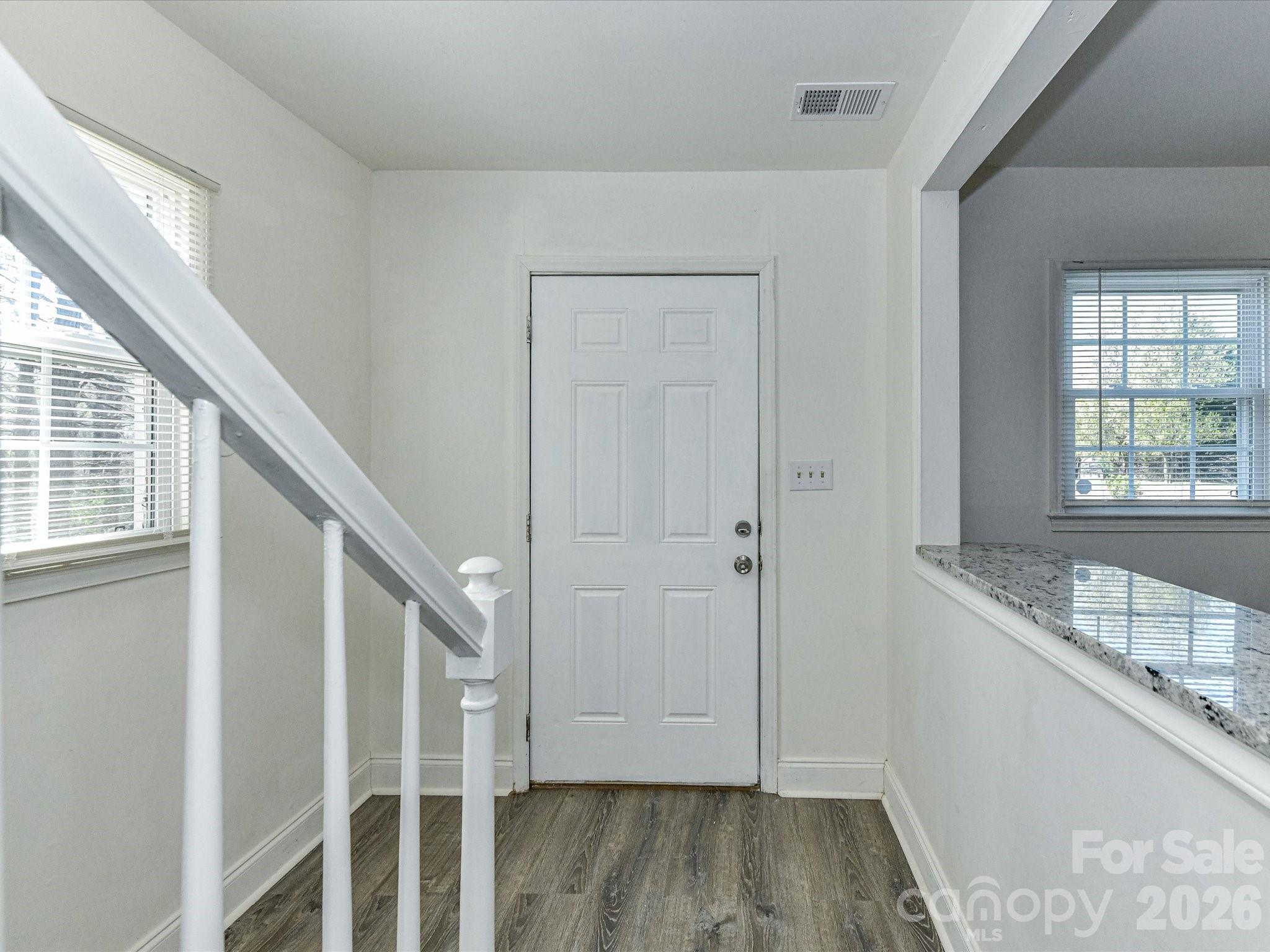 8322 Knights Bridge Road Charlotte, NC 28210 - Photo 8 of 37 a view of an entryway with wooden floor and staircase