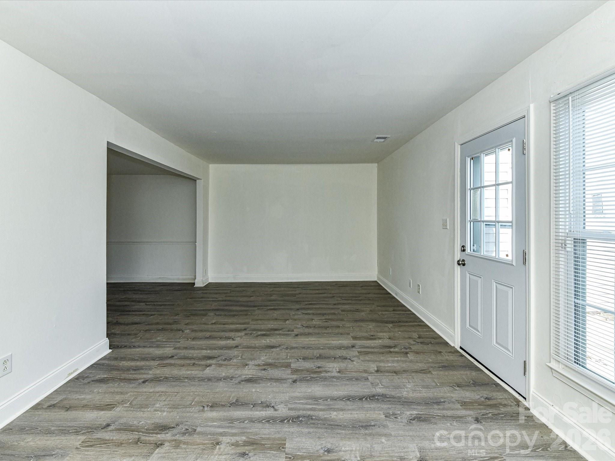 8322 Knights Bridge Road Charlotte, NC 28210 - Photo 9 of 37 wooden floor in an empty room with a window