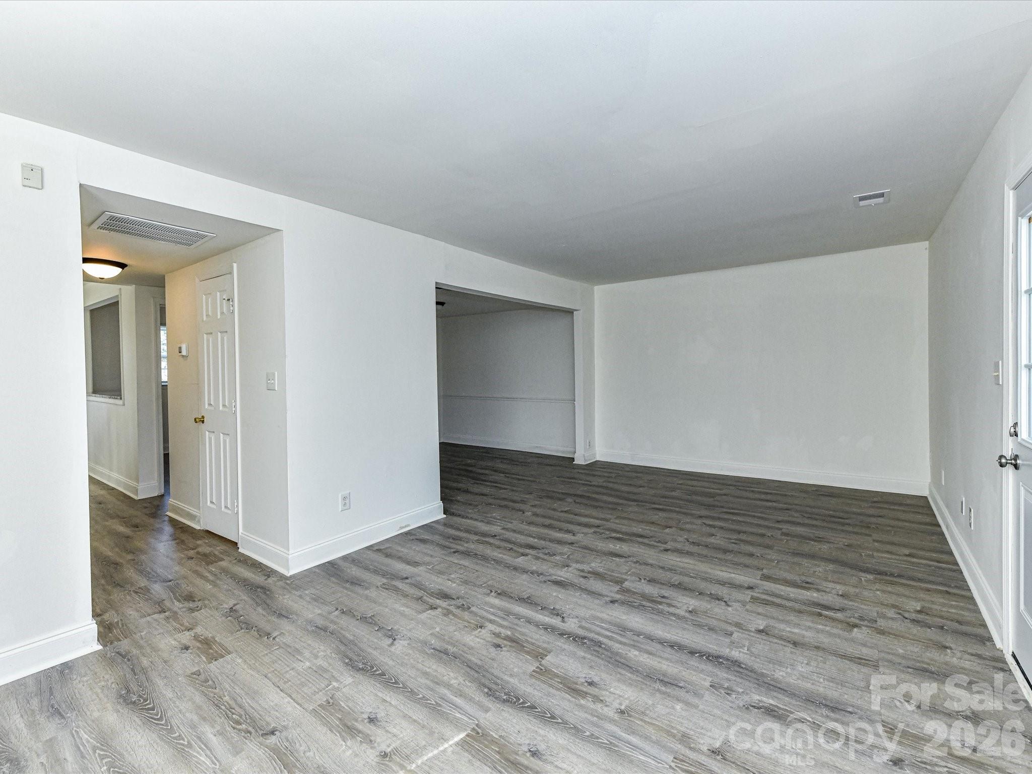 8322 Knights Bridge Road Charlotte, NC 28210 - Photo 10 of 37 a view of an empty room with wooden floor and closet
