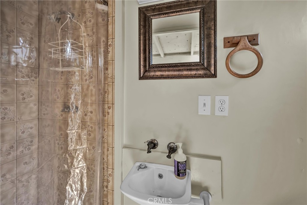 12800 Anderson Road Lower Lake, CA 95457 - Photo 13 of 20 a bathroom with a sink a toilet and a mirror