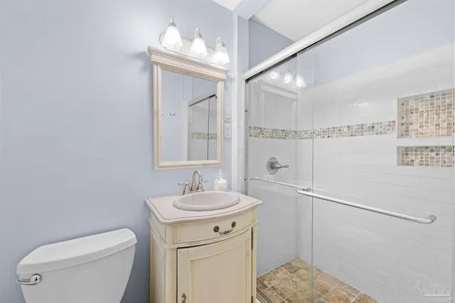a view of a bedroom with furniture and fan