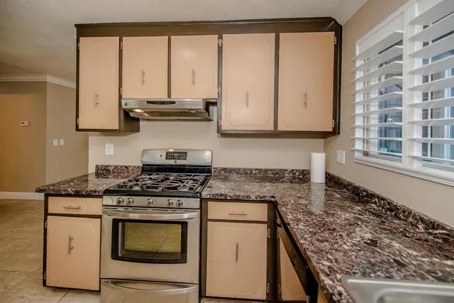 a stove top oven sitting inside of a kitchen