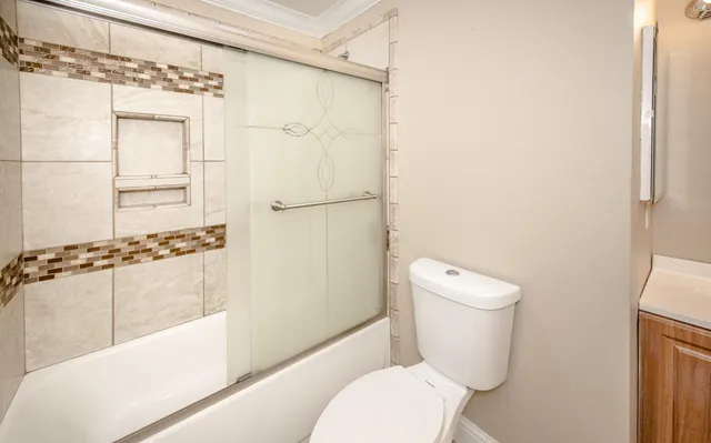 a white toilet sitting next to a bathroom sink