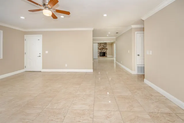 a view of a livingroom with a ceiling fan and window