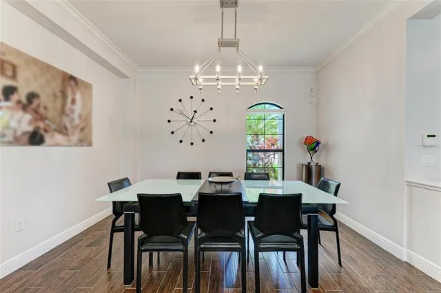 a kitchen with stainless steel appliances kitchen island granite countertop a sink and a refrigerator
