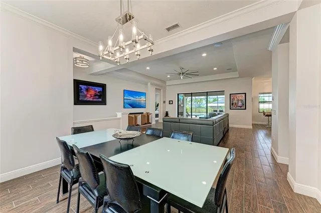 a view of a dining room with furniture large window and wooden floor