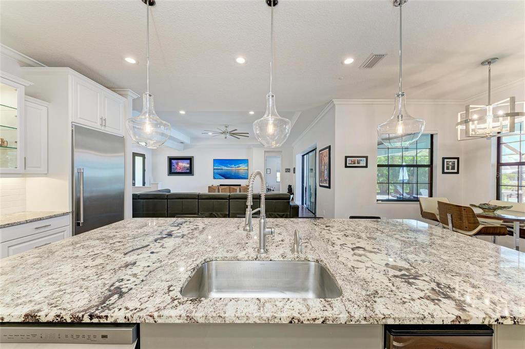 544 Fore Drive Bradenton, FL 34208 - Photo 22 of 95 a kitchen with stainless steel appliances kitchen island granite countertop a sink and a refrigerator
