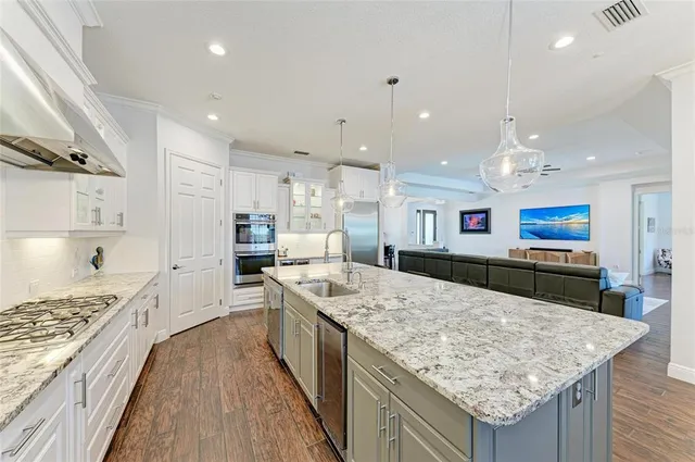 a spacious bathroom with double vanity a mirror a bathtub and window