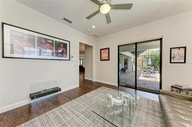a view of an empty room with glass door and windows