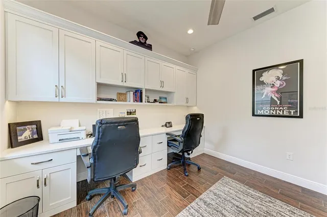 a bedroom with a large bed and ceiling fan