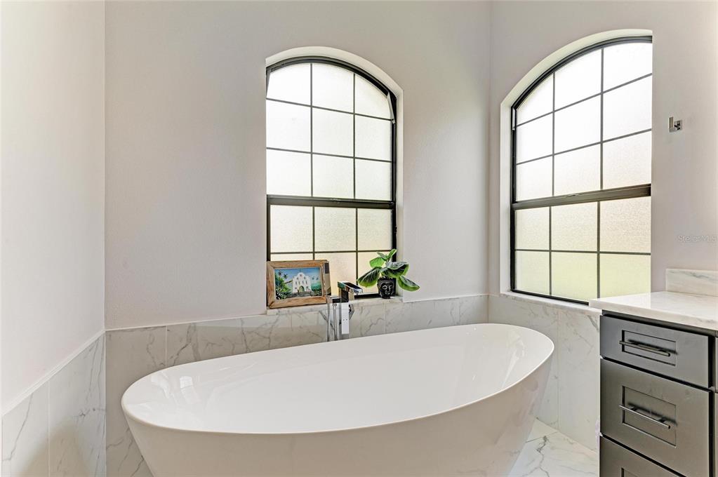 544 Fore Drive Bradenton, FL 34208 - Photo 41 of 95 an white bath tub sitting in a bathroom next to a window