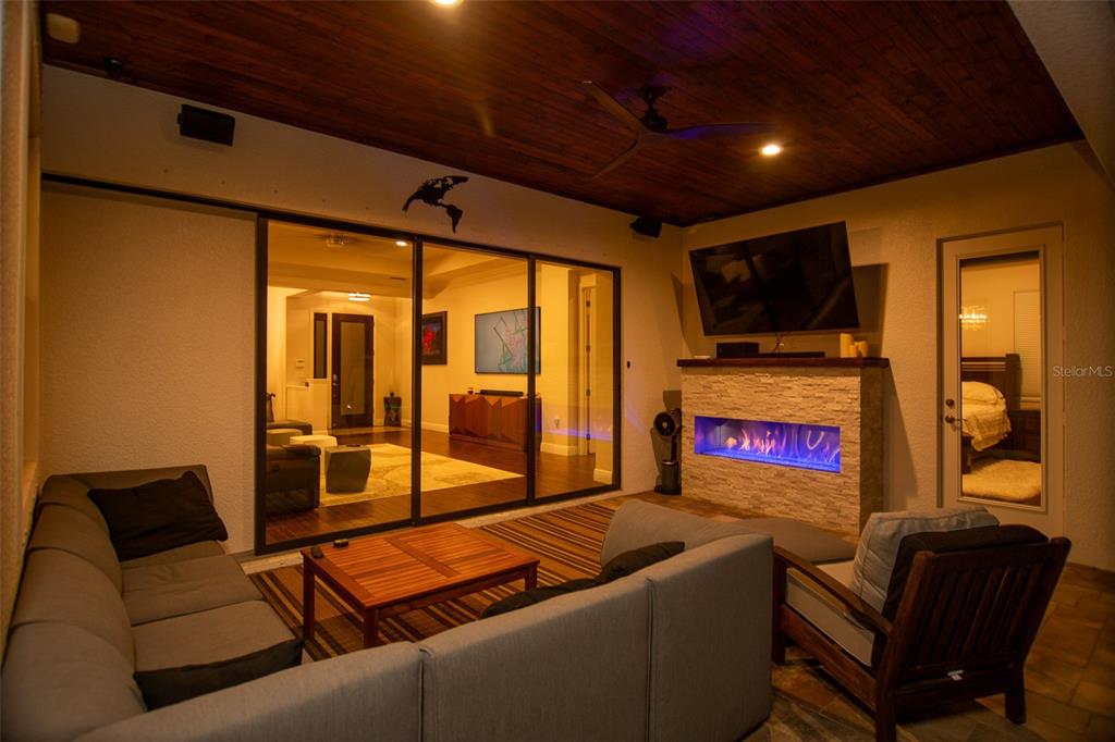 544 Fore Drive Bradenton, FL 34208 - Photo 83 of 95 a living room with furniture a flat screen tv and a floor to ceiling window