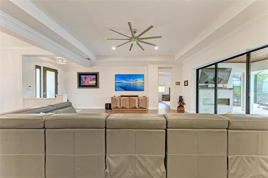 544 Fore Drive Bradenton, FL 34208 - Photo 9 of 95 a living room with couches a fireplace and a large window