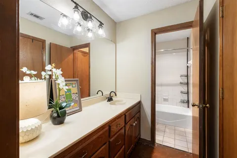 a bathroom with a double vanity sink and a mirror