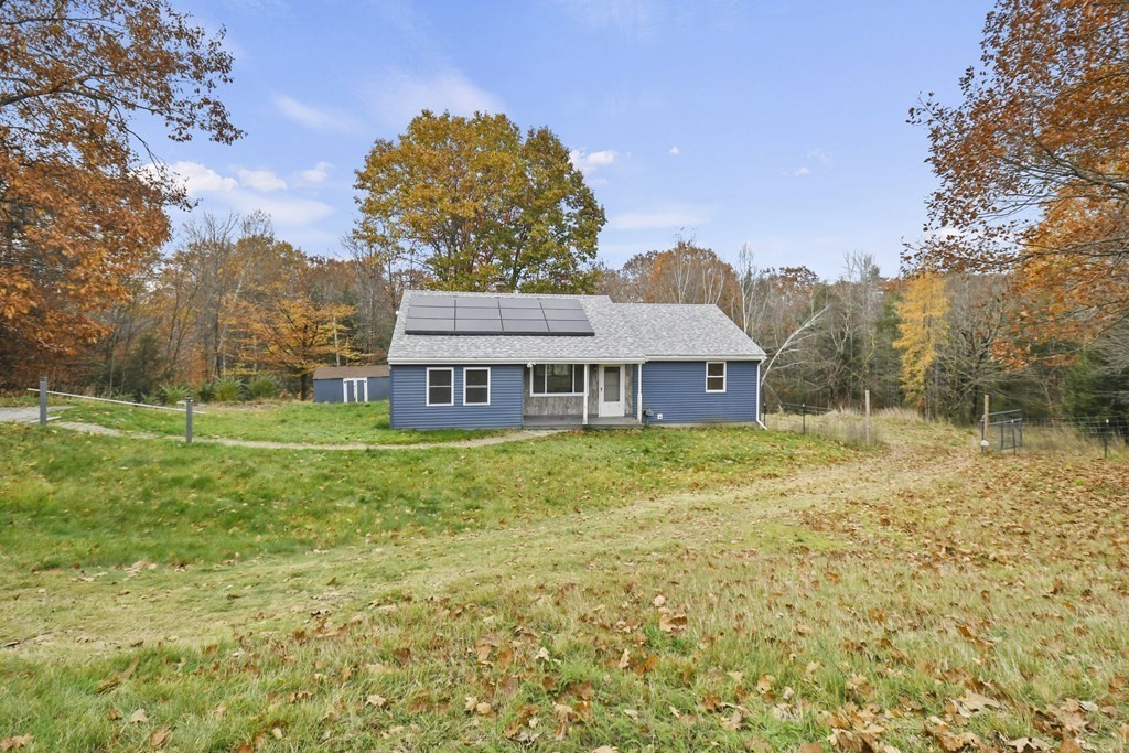 50 Perry Road Rindge, NH 03461 - Photo 1 of 36 a front view of a house with garden
