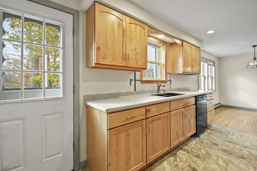 50 Perry Road Rindge, NH 03461 - Photo 14 of 36 a kitchen with stainless steel appliances granite countertop white cabinets a sink and a large window