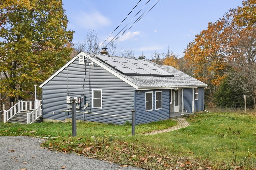 50 Perry Road Rindge, NH 03461 - Photo 3 of 36 a view of a house with a yard plants and large tree