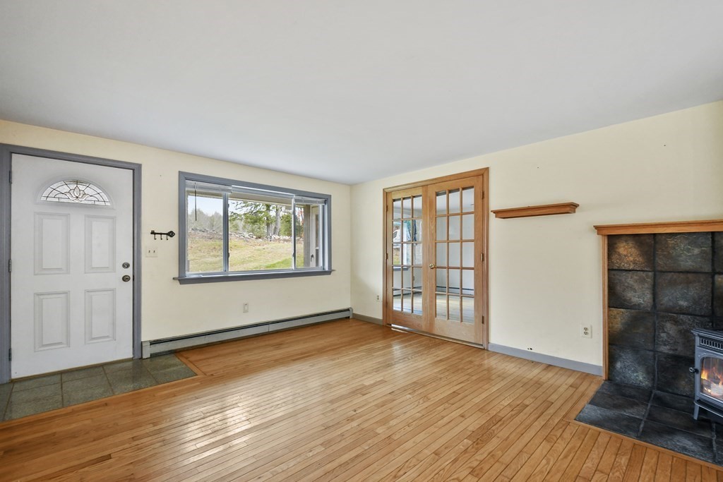 50 Perry Road Rindge, NH 03461 - Photo 4 of 36 an empty room with wooden floor and windows