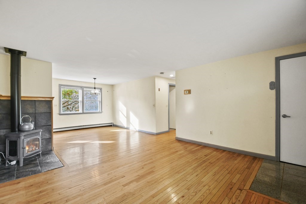 50 Perry Road Rindge, NH 03461 - Photo 6 of 36 a view of a livingroom with wooden floor and a flat screen tv