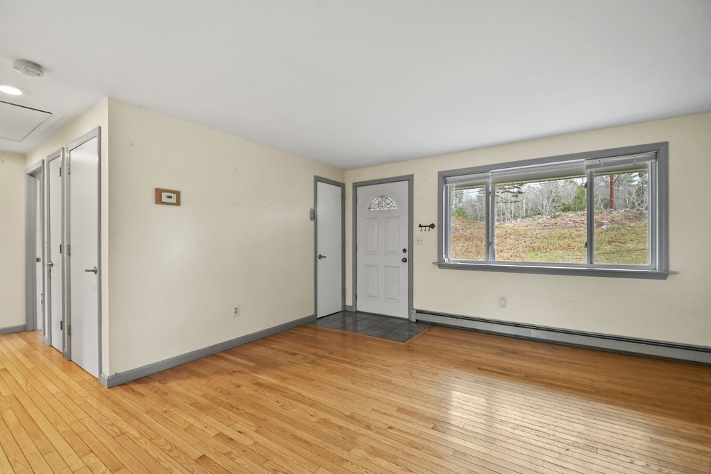 50 Perry Road Rindge, NH 03461 - Photo 7 of 36 a view of an empty room with wooden floor and a window