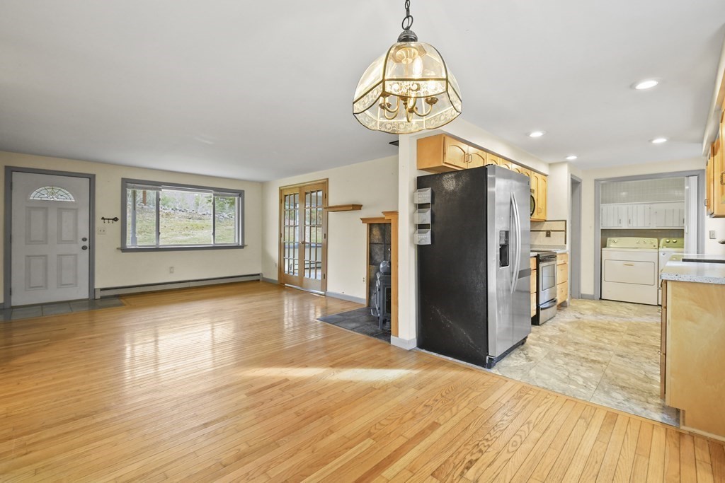 50 Perry Road Rindge, NH 03461 - Photo 10 of 36 a view of a kitchen with refrigerator and wooden floor
