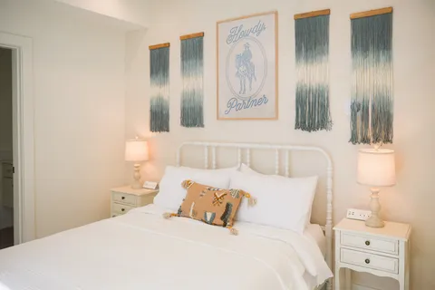 a bedroom with a bed and a lamp