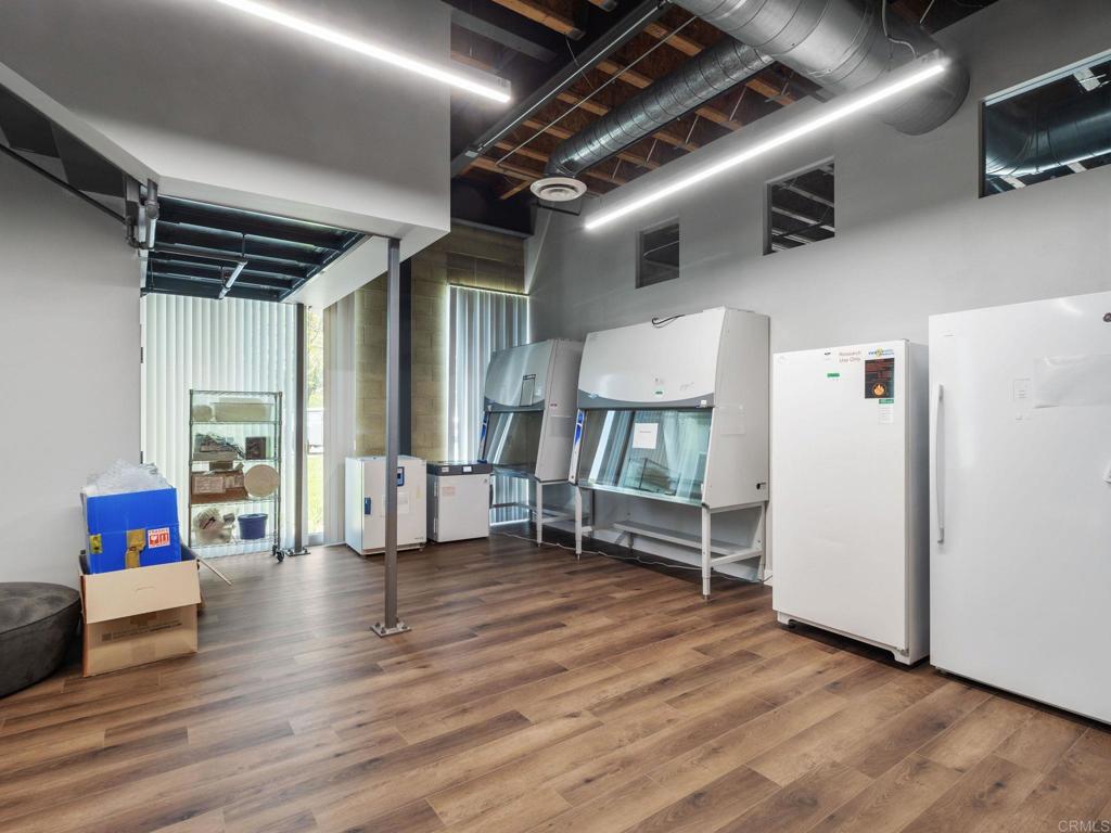 8945 Research Drive Irvine, CA 92618 - Photo 13 of 59 a view of an empty room with wooden floor and a window