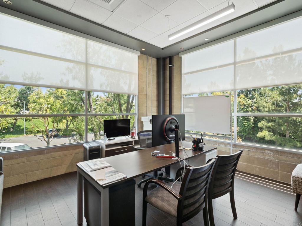 8945 Research Drive Irvine, CA 92618 - Photo 20 of 59 a dining room with a table chairs and a wooden floor