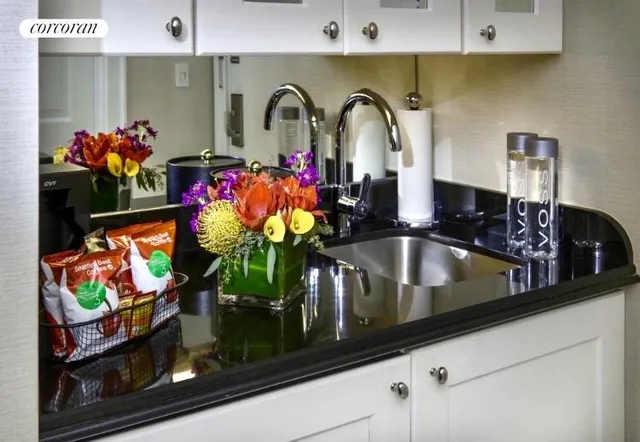 a kitchen with stainless steel appliances kitchen island granite countertop a stove a sink and a microwave