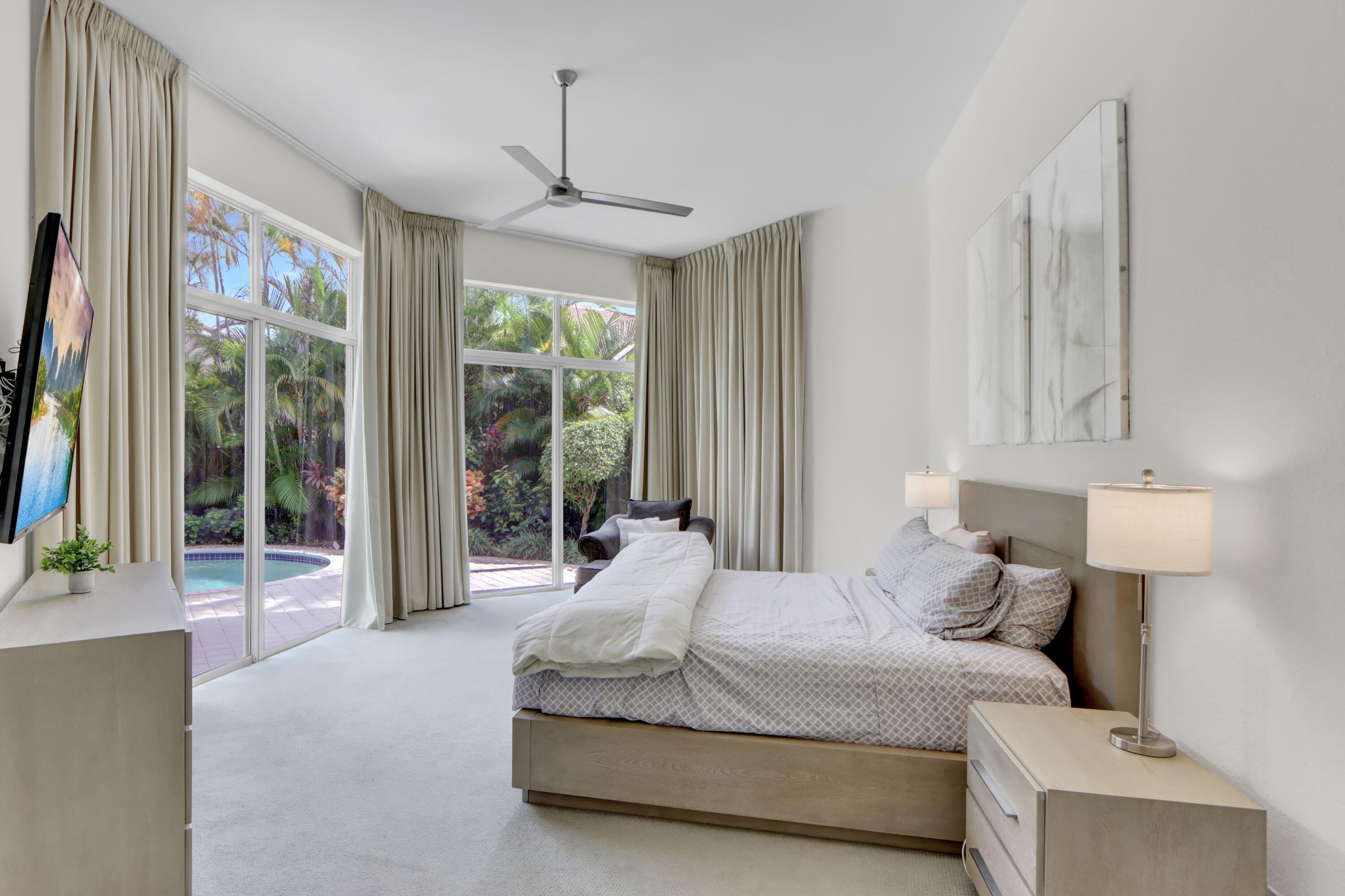 6564 Somerset Circle Boca Raton, FL 33496 - Photo 10 of 39 a bedroom with a large bed and a window