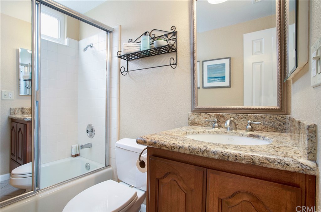 15832 Monroe Street Westminster, CA 92683 - Photo 11 of 32 a bathroom with a granite countertop sink toilet and shower
