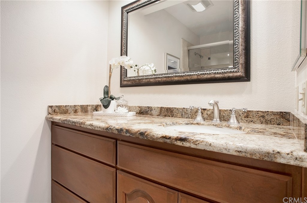 15832 Monroe Street Westminster, CA 92683 - Photo 17 of 32 a bathroom with a granite countertop sink and a mirror