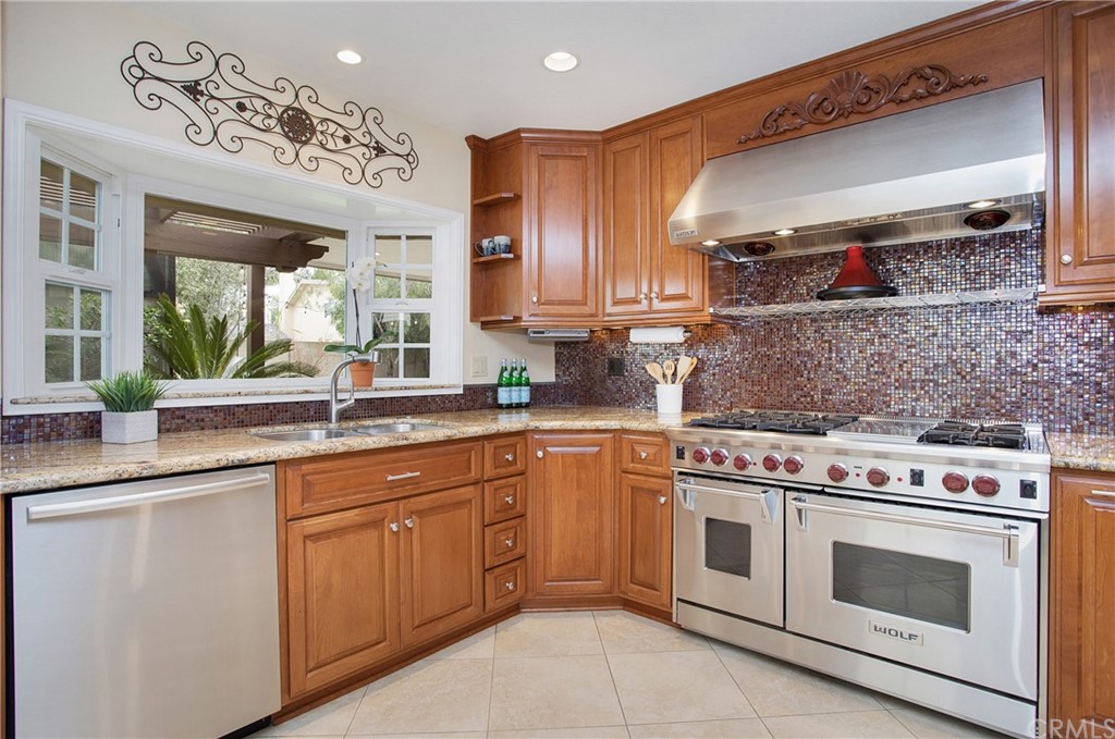 15832 Monroe Street Westminster, CA 92683 - Photo 5 of 32 a kitchen with a stove top oven sink and cabinets