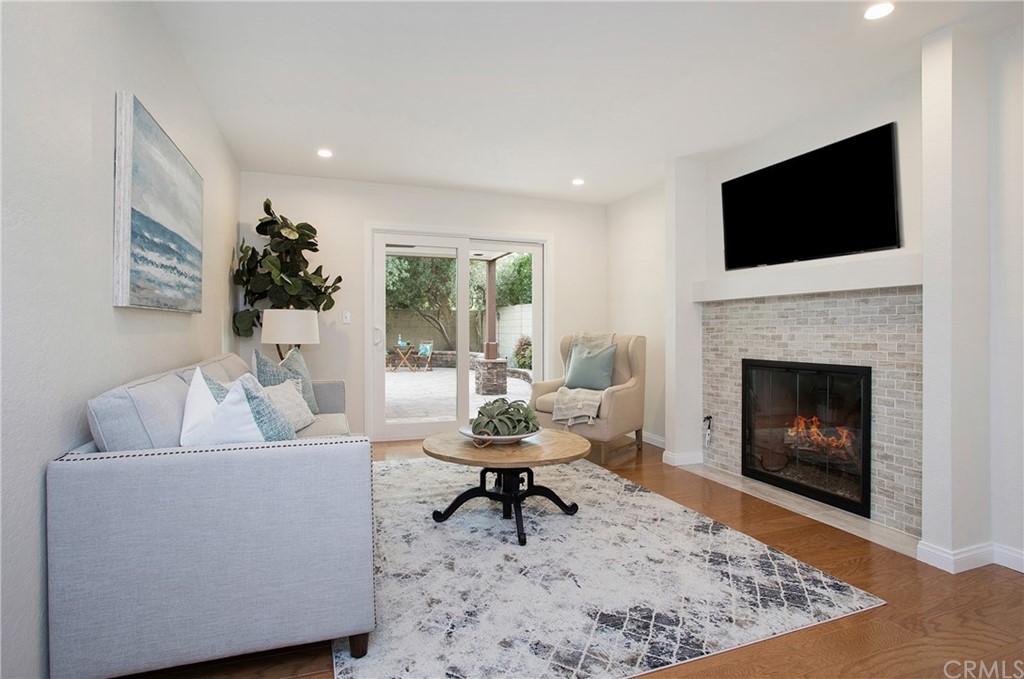 15832 Monroe Street Westminster, CA 92683 - Photo 7 of 32 a living room with furniture a flat screen tv and a fireplace