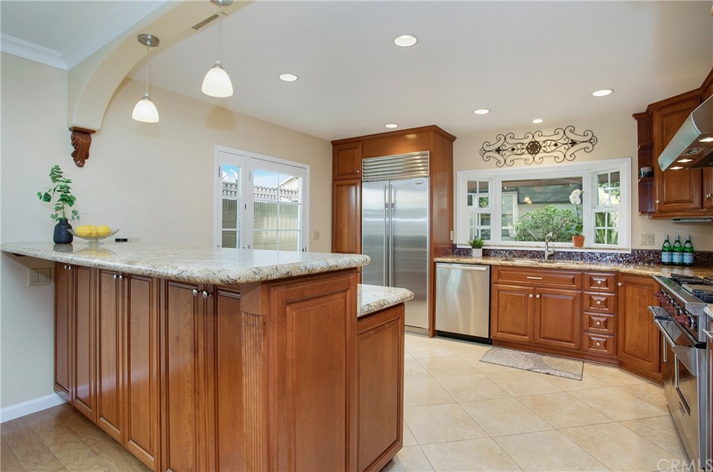 15832 Monroe Street Westminster, CA 92683 - Photo 10 of 32 a kitchen with granite countertop a sink and a refrigerator