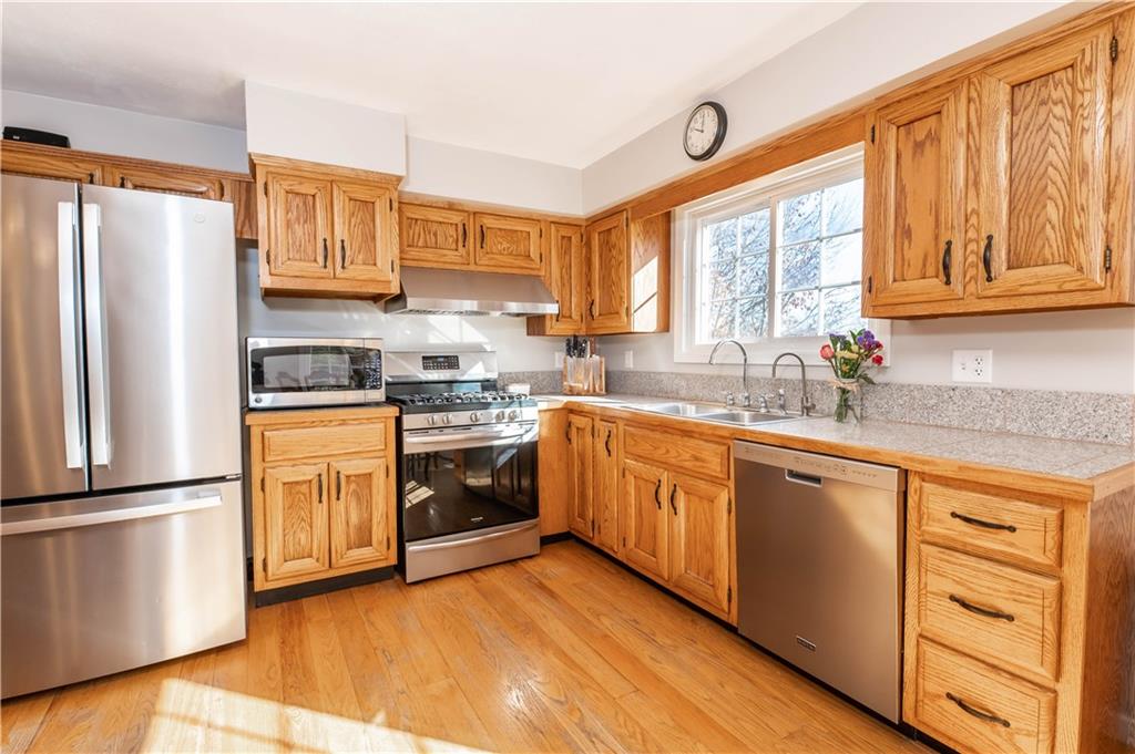2555 Morrow Road Home, PA 15747 - Photo 5 of 24 a kitchen with stainless steel appliances granite countertop a refrigerator a sink dishwasher a stove and white cabinets with wooden floor