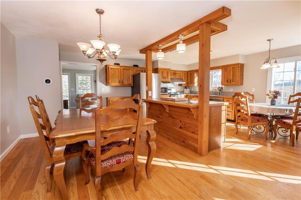 2555 Morrow Road Home, PA 15747 - Photo 6 of 24 a view of a dining room with furniture a chandelier and wooden floor