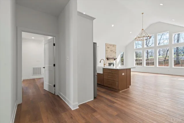 a large kitchen with kitchen island a sink stainless steel appliances and cabinets