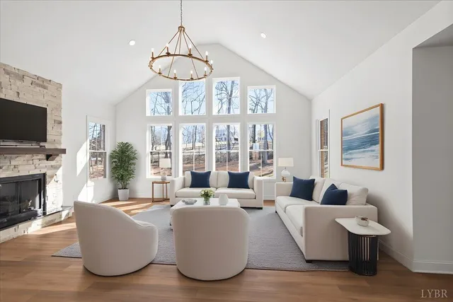 a bedroom with a large bed chandelier and a window