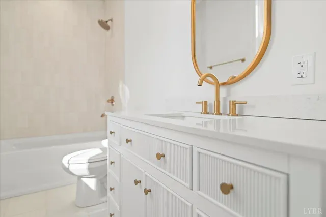 a view of an empty room with wooden floor and window