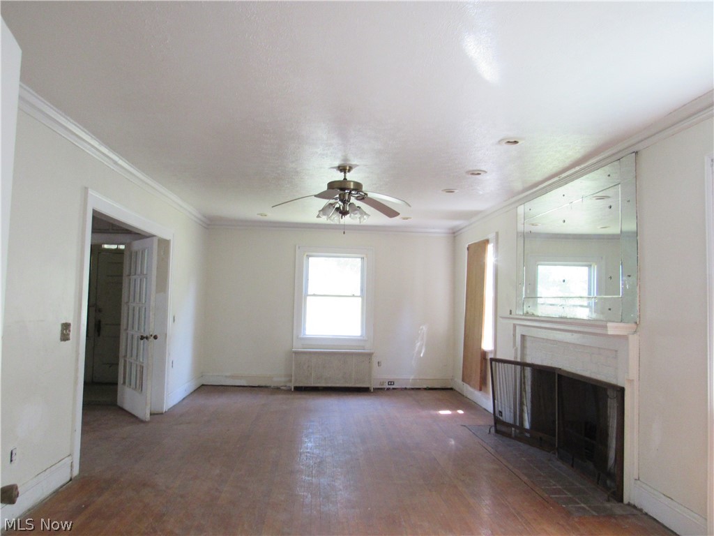 1726 Lee Road Cleveland Heights, OH 44118 - Photo 2 of 36 Spacious room featuring wood-finish flooring, a built-in fireplace with an ornate mantel, a ceiling fan, and recessed lighting