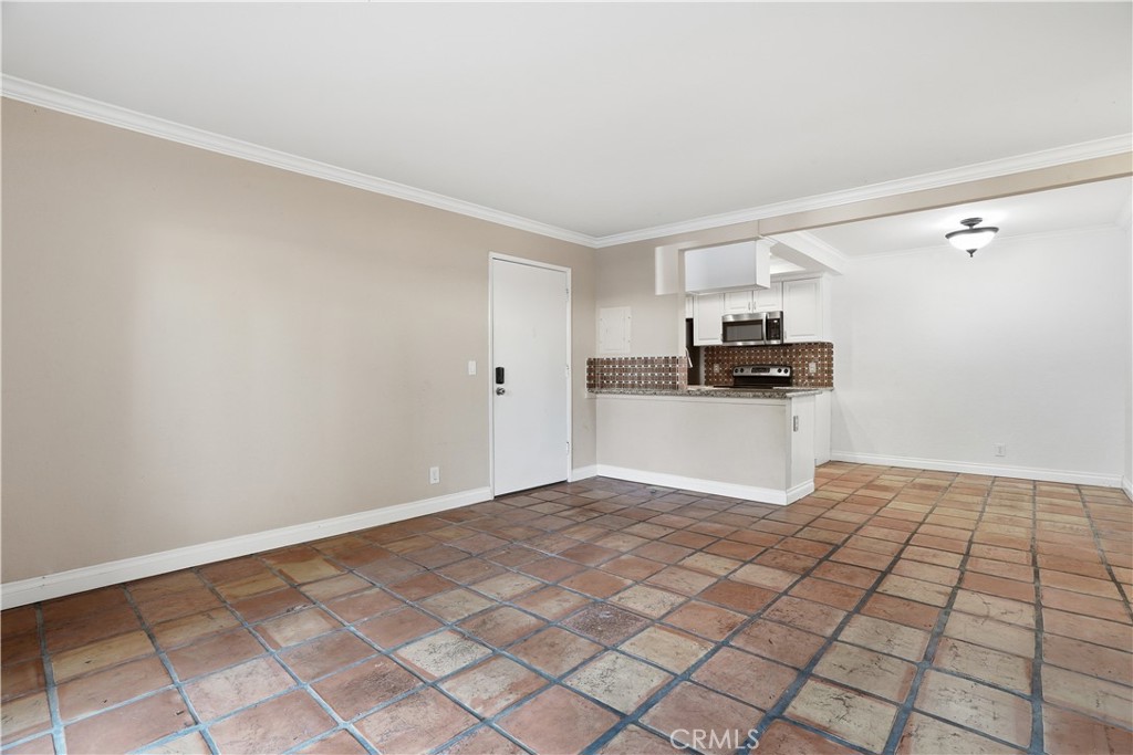 20702 El Toro Road, Unit 231 Lake Forest, CA 92630 - Photo 16 of 36 a view of a kitchen with white cabinets and black appliances