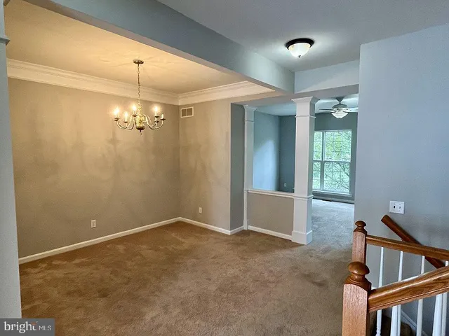 an empty room with closet and a ceiling fan