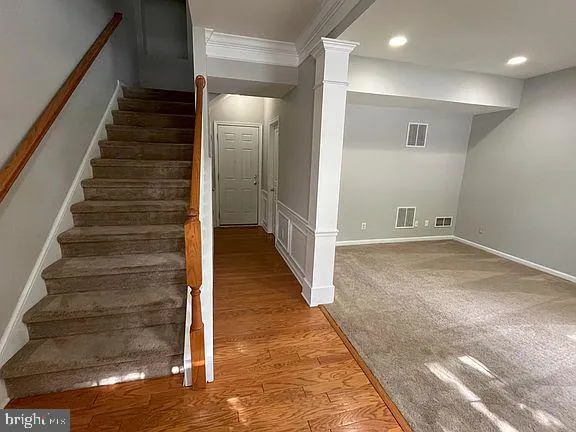 a view of entryway and hall with wooden floor