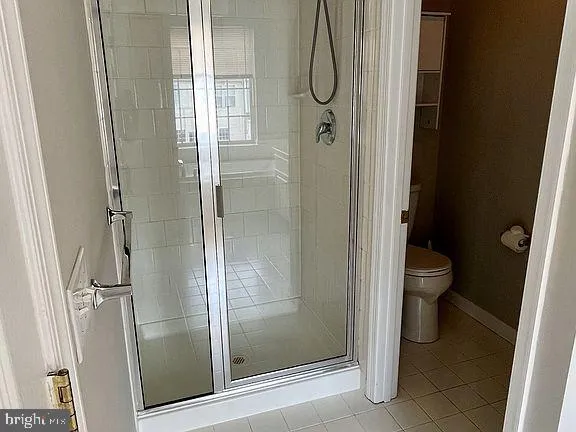 an empty room with closet and a chandelier fan