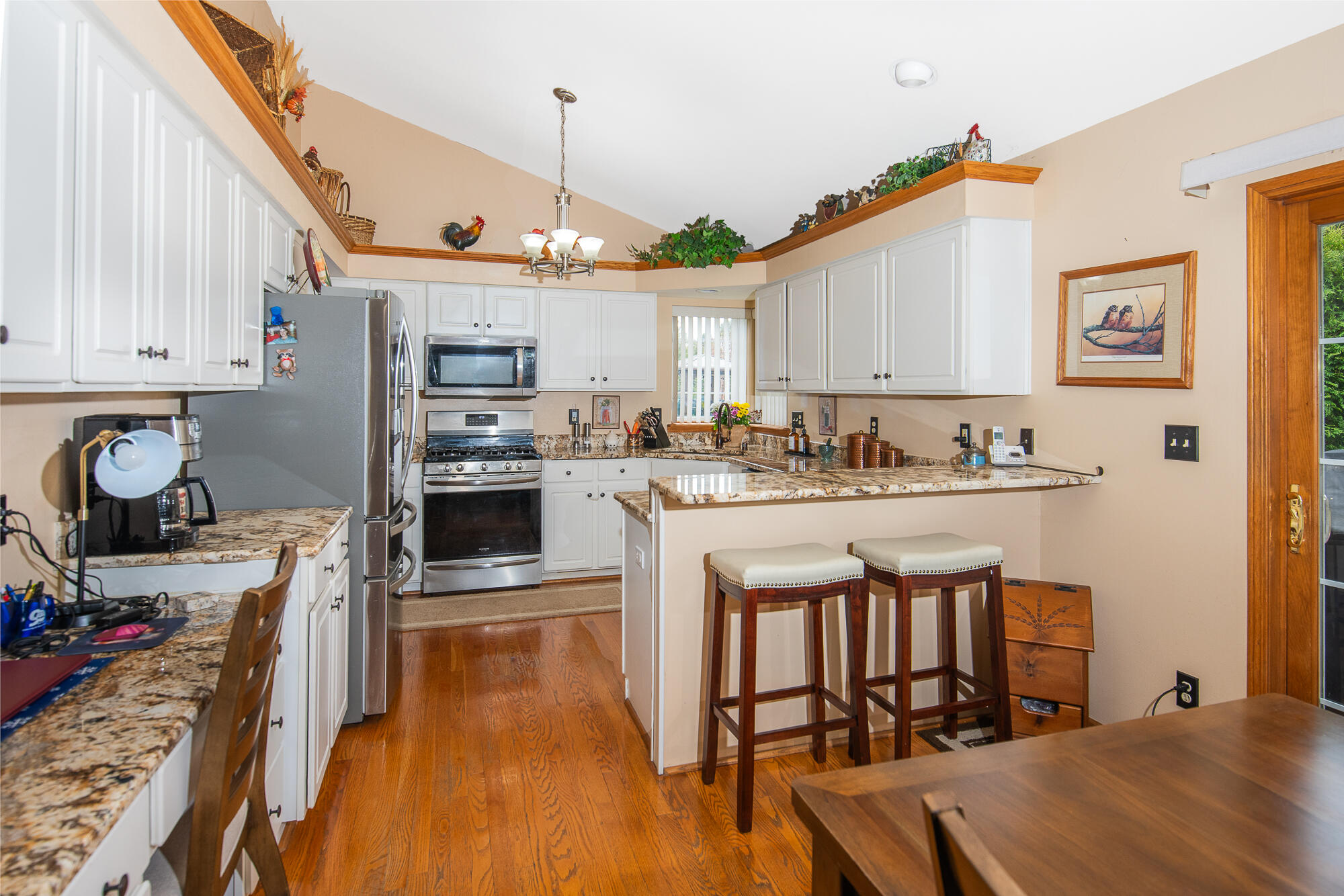 6423 Anforest Lane Mount Pleasant, WI 53406 - Photo 6 of 31 Kitchen with granite counter tops and hardwood floor