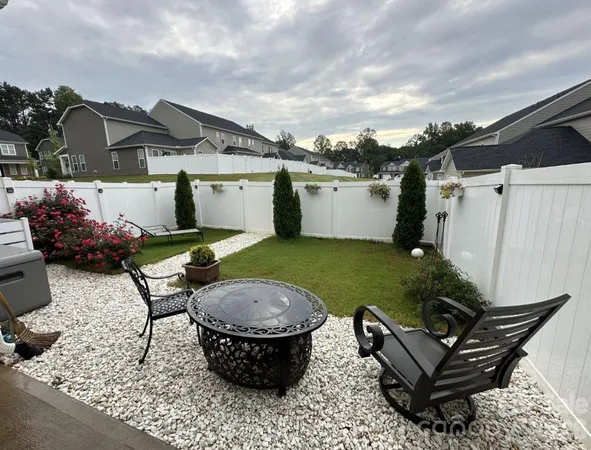 a view of a backyard with sitting area